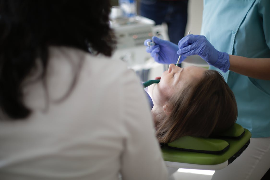 a woman on the dentist chair receiving dental care