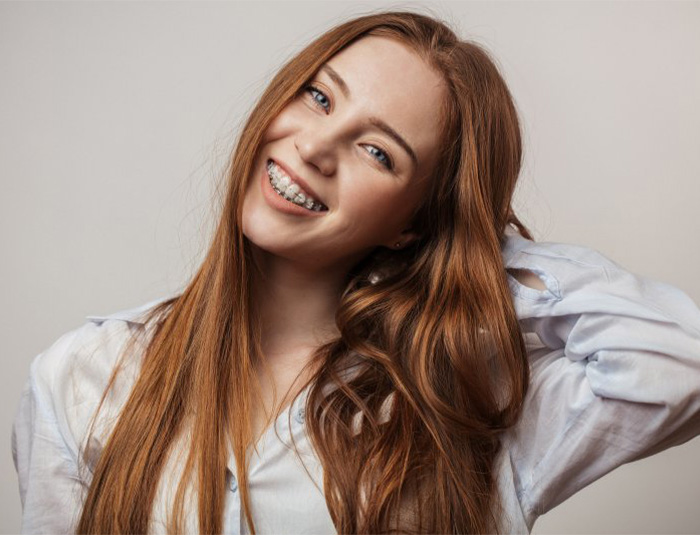 Teen smiles with braces.
